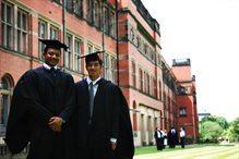 Two graduands in their robes, outside Aston Webb
