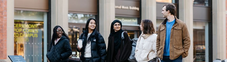 students walking past the Bramall Music Building