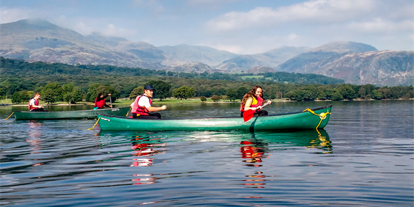 Two people in a canoe paddling in Coniston Water