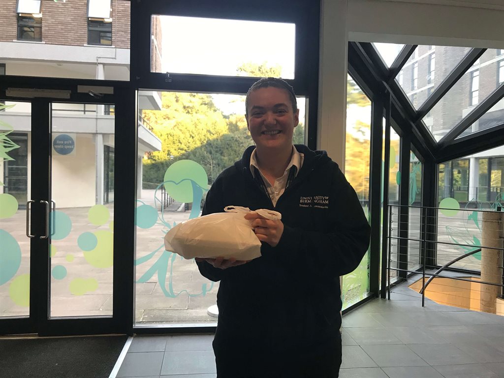 Member of the accommodation team delivering food to students