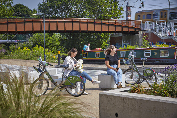 Two students sat with their West Midlands Cycle Hire bikes by the canal.