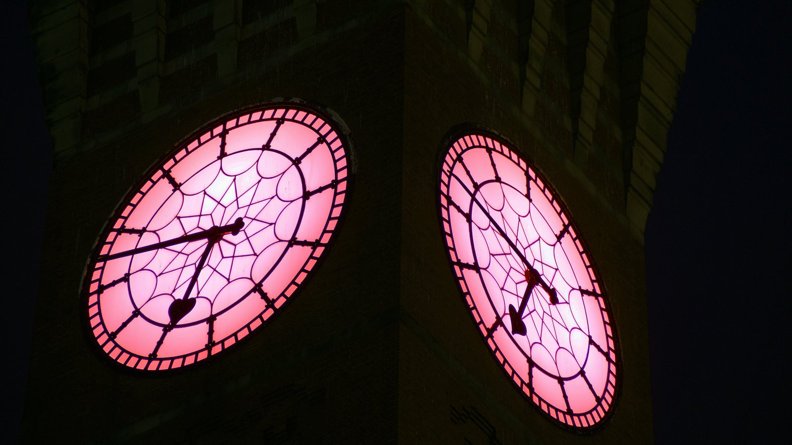A close-up of Old Joe's clockface which is lit up pink