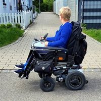 A woman in a wheelchair assessing building access