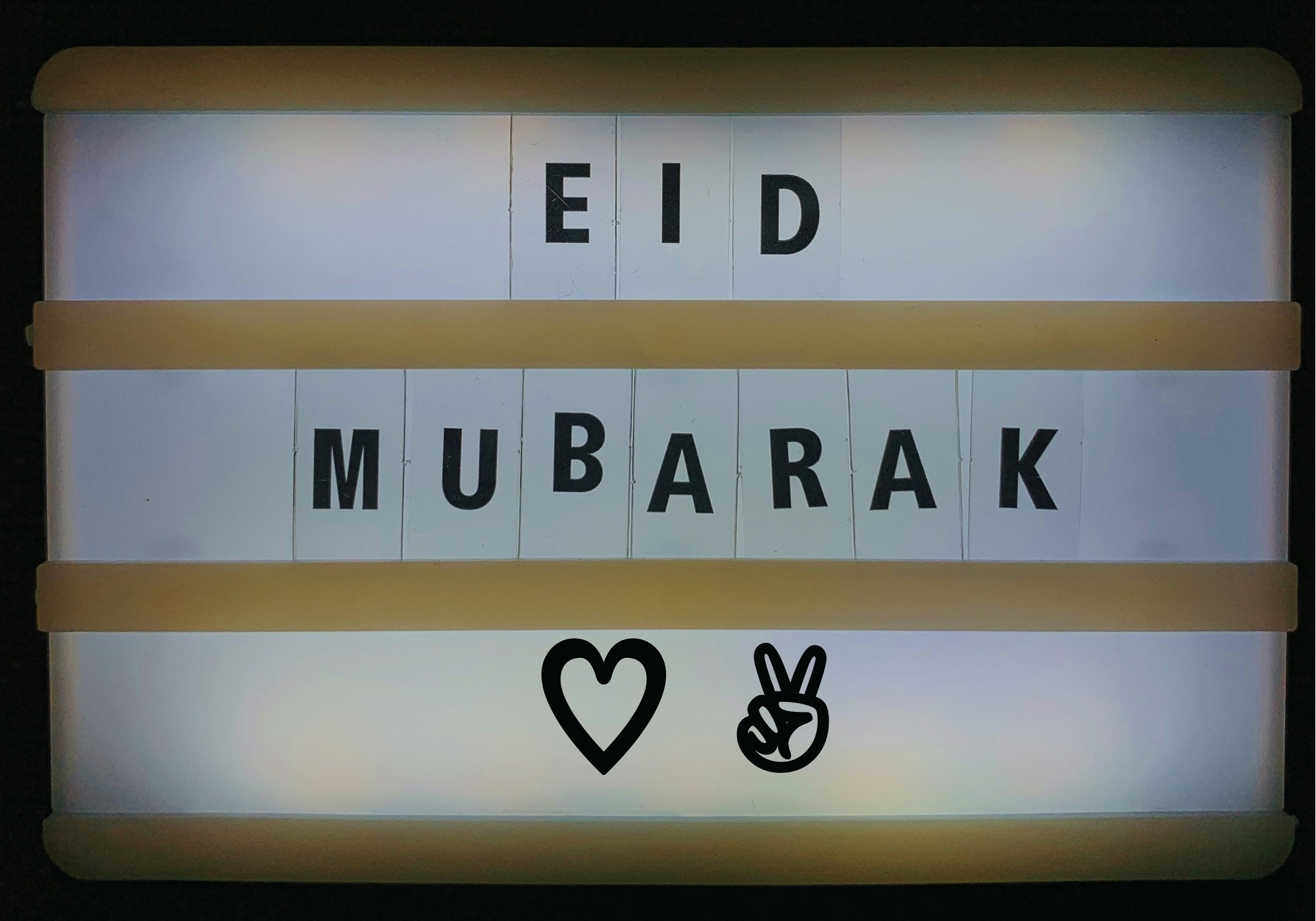A backlit sign with the words Eid Mubarak