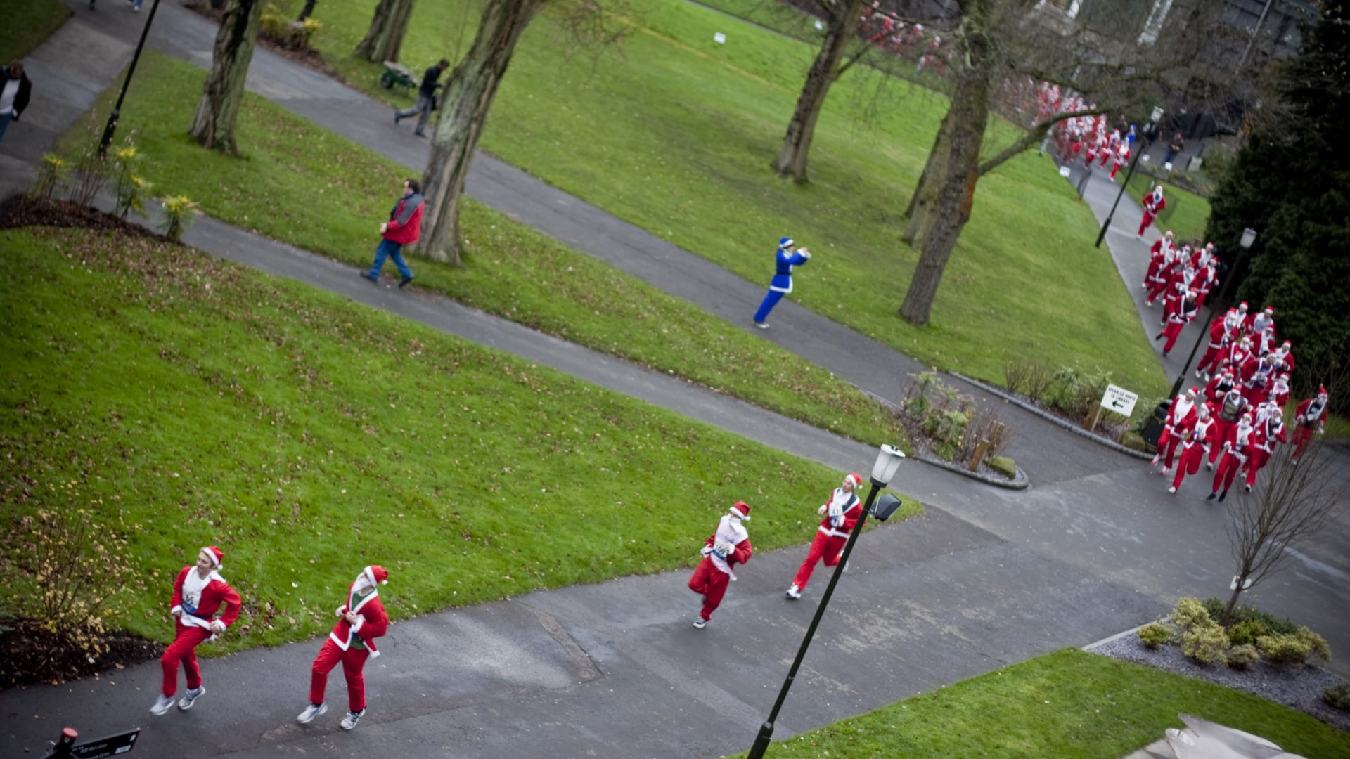 Members of staff dressed as Santa Claus run through University Square for the Santa Run.