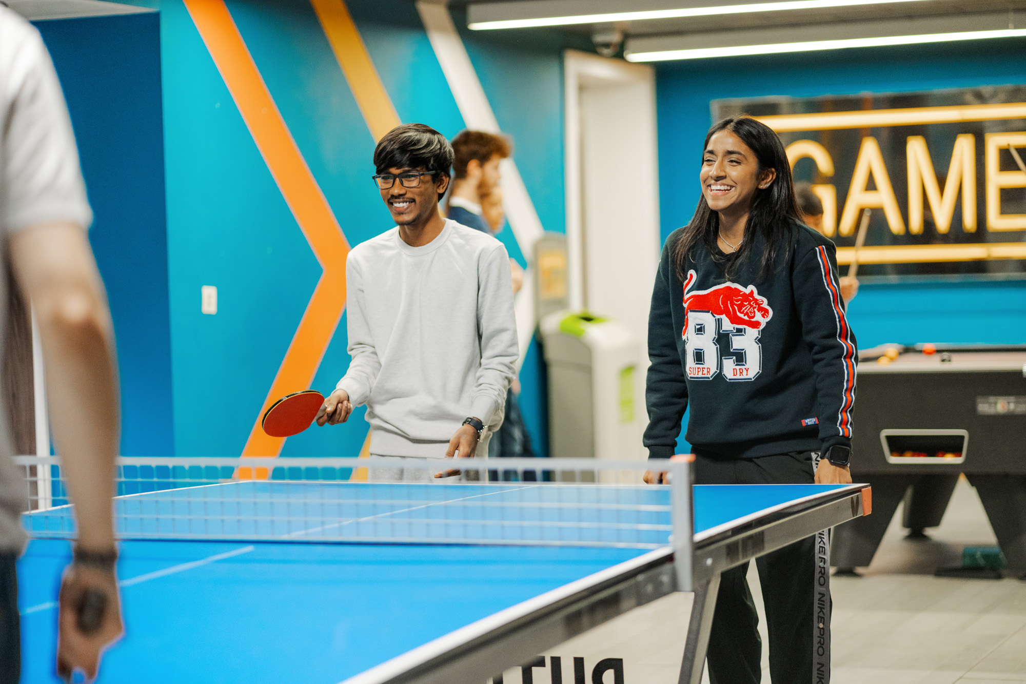 Students playing table tennis in their accommodation.