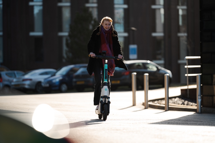 Student travelling by Beryl e-scooter on campus.