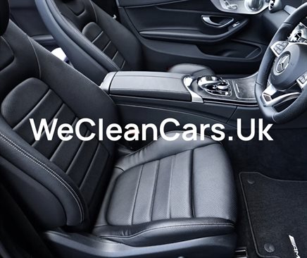 WeCleanCars.UK written in white text in front of the interior of a car.