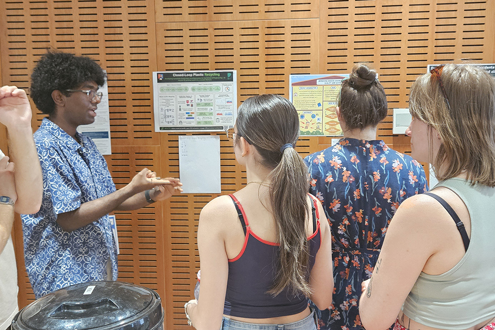 Students gathering in a lecture hall to view poster showcase