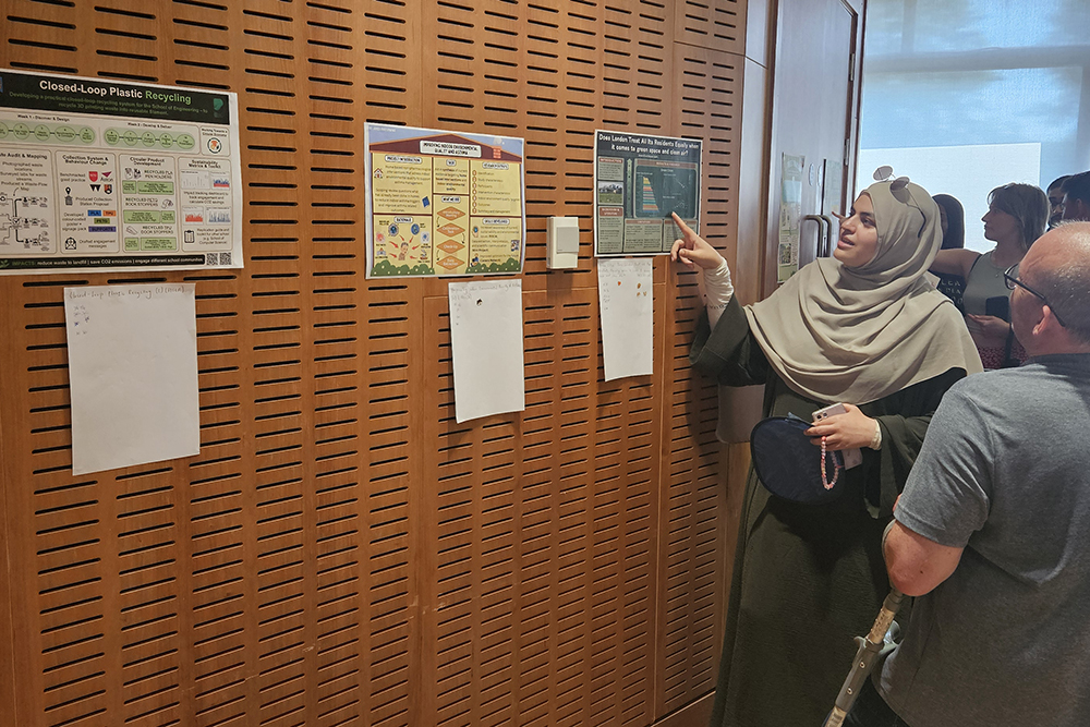 Students gathering in a lecture hall to view poster showcase