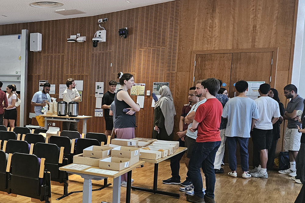 Students gathering in a lecture hall to view poster showcase