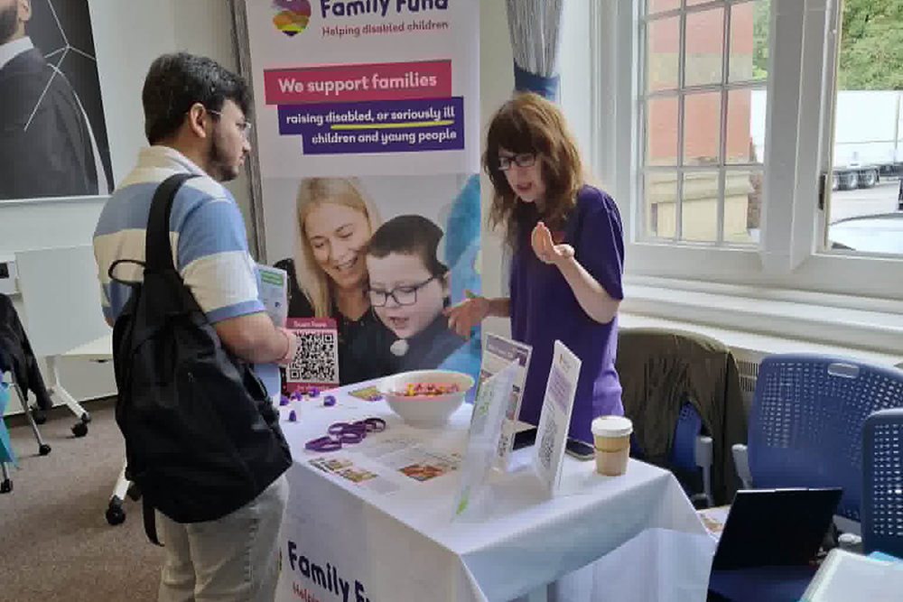 An exhibitors talking to a student