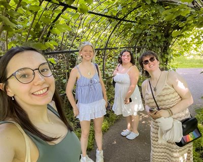 A group of four girls smile at the camera in Winterbourne Garden