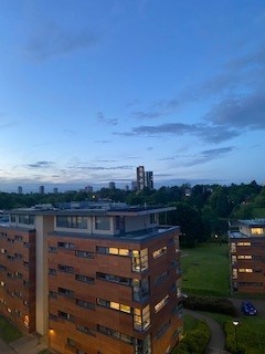 A student accommodation block pictured in the evening, as the sun is setting.