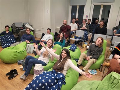 A photo of Katrina and friends smiling sat on green beanbags.