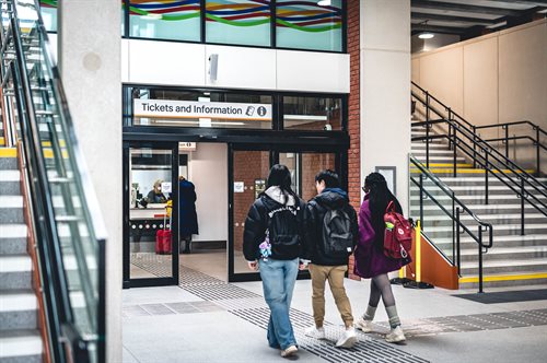 Students entering train ticket office