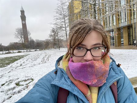 Eleanor is standing in front of Old Joe in the snow.