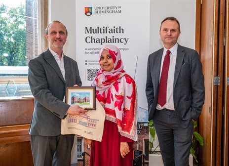 Vice Chancellor, student and Aziz Foundation member posing with award